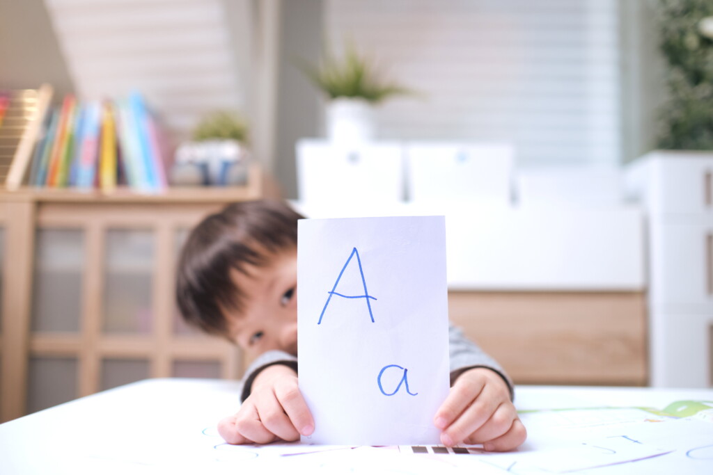 Kindergarten boy playing with flash cards